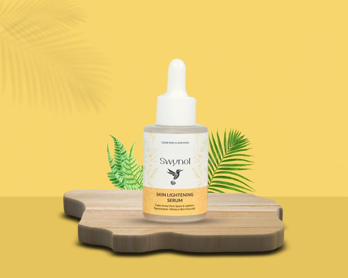Swynol Skin Lightening Serum bottle with mulberry extract placed on a wooden tray, styled with leaves on a soft yellow background for a fresh, natural feel. highlighting its targeted solution for uneven skin tone and dark spots.