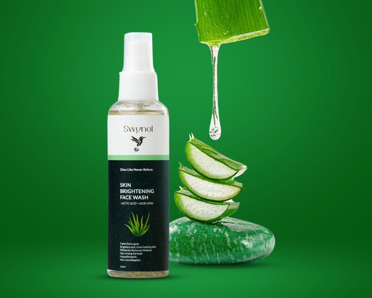 Face Wash bottle with Aloe Vera & Lactic Acid beside fresh aloe vera pouring out, symbolizing hydration, gentle exfoliation, and skin-calming care.